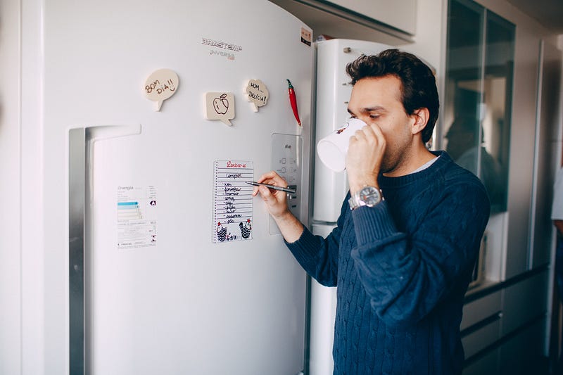 Young man managing tasks and enjoying a cup of coffee