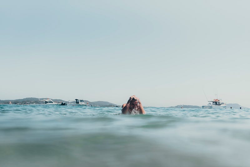 Swimmer enjoying the ocean while being aware of health implications.